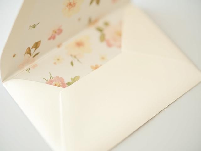 Ornate envelope liner with botanical design inside a wedding invitation envelope